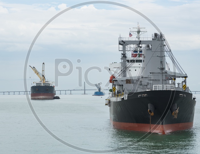 Cargo ships sailing past the Penang Bridge