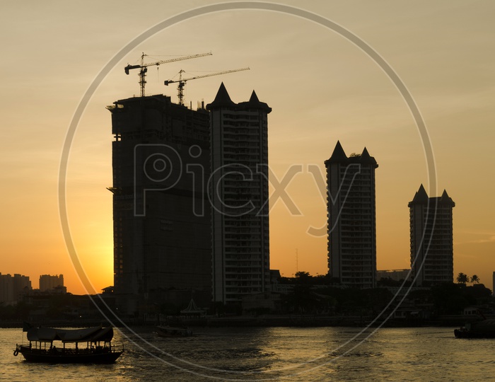 High Rise Apartments Construction with Sunset in Background, Thailand