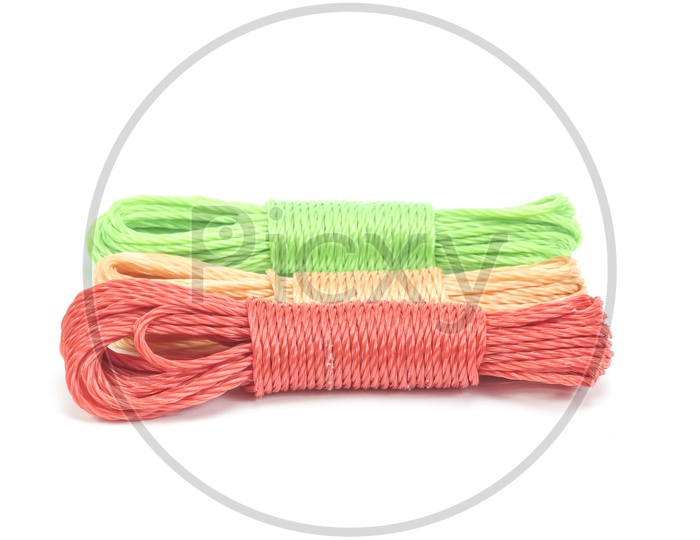 Image of bundles of colorful nylon ropes on white background