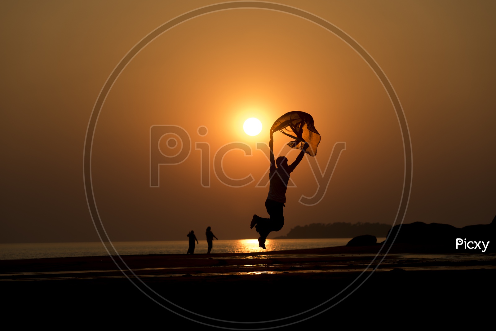 silhouette of a jumping with scarf during Thailand sunset