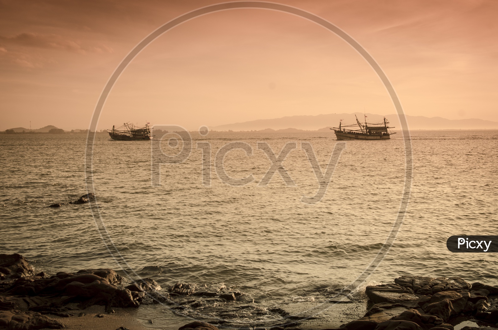 Sunrise over the sea and fishing boat in countryside of Hua Hin , Thailand