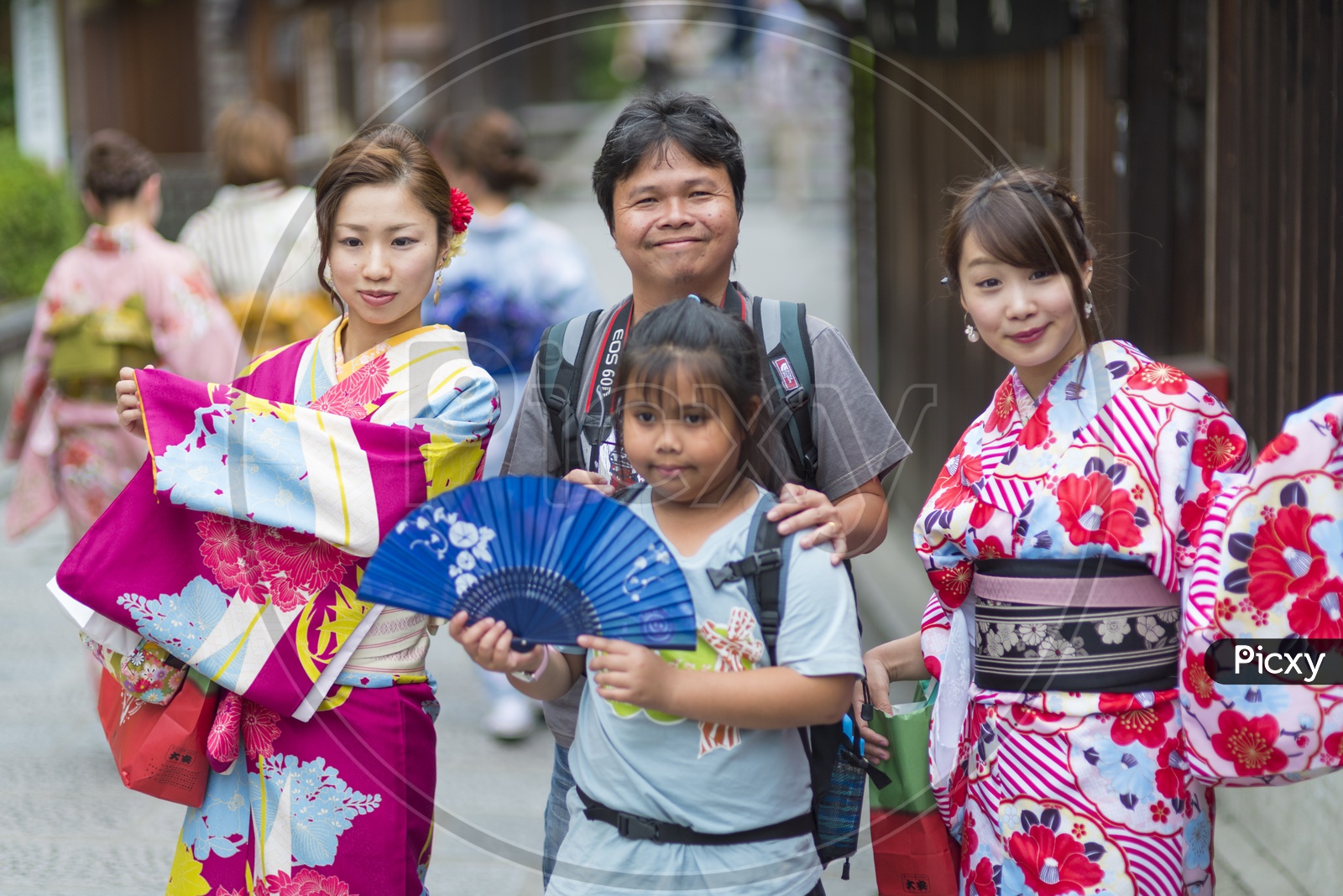 A Japanese Photographer posing with local people