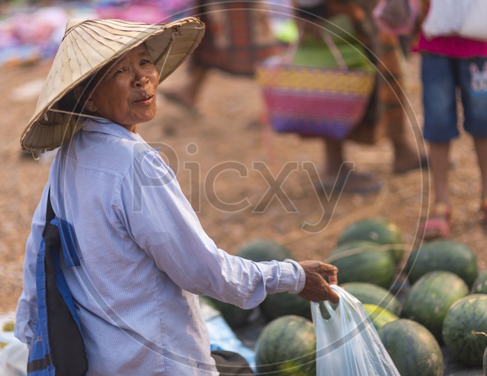 Woman Selling Watermelons in a Market, Laos