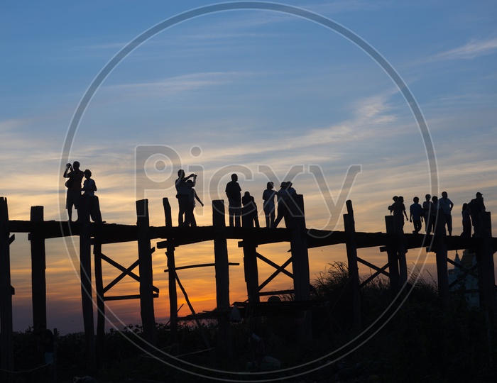 Tourists taking pictures on U Bein Bridge during sunset in Amarapura, Myanmar Burma