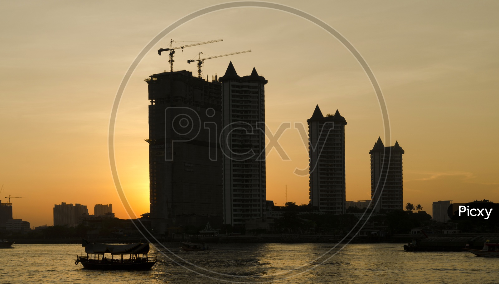 High Rise Apartments Construction with Sunset in Background, Thailand