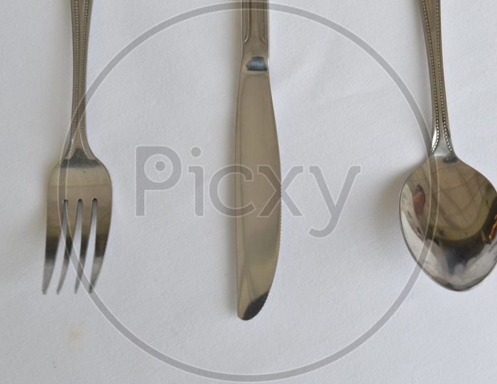 Fork, Spoon And Knife On a Restaurant Dining Table