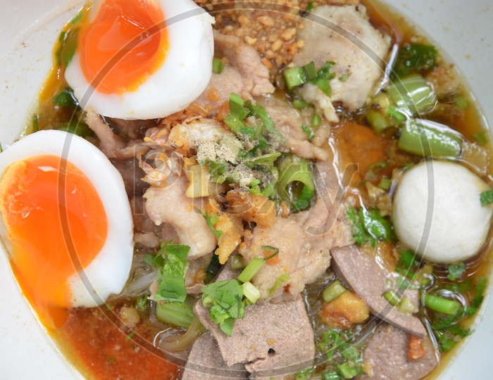 Closeup of Thai pork Noodles with Boiled eggs