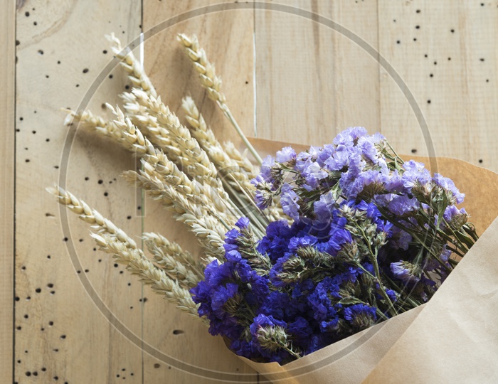 Flowers in a Bouquet on Wooden Background