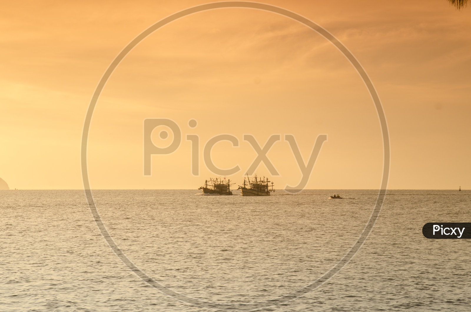 Sunrise over the sea and fishing boat in countryside of Hua Hin , Thailand