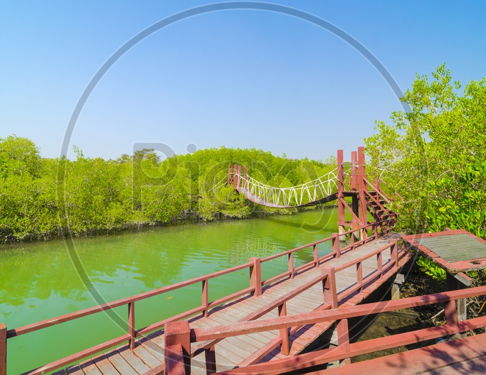 A View Of Red Wooden Suspended Bridge Over Krabi River In Mangrove Forest