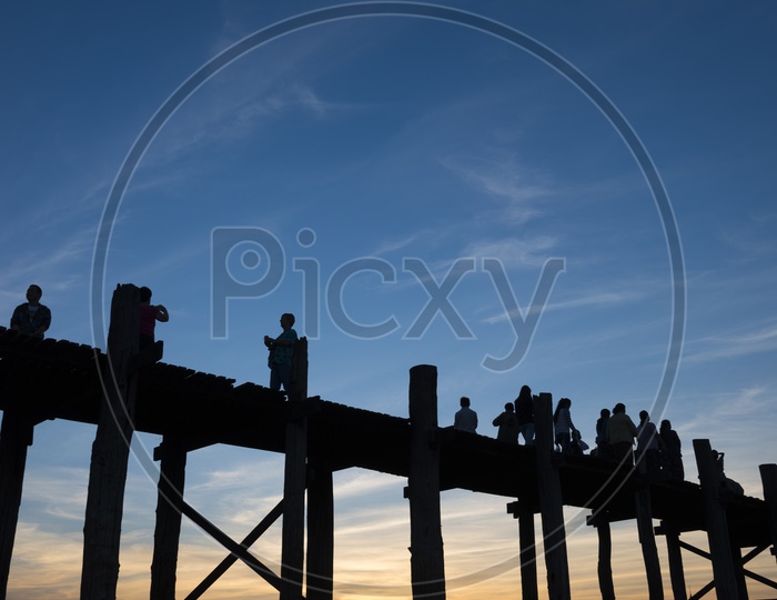 Tourists on U Bein Bridge during sunset in Amarapura, Myanmar Burma