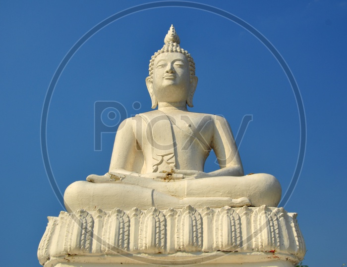 A White Buddha statue with blue sky in Thailand