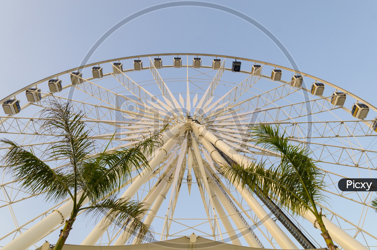 A Large Ferris wheel in the blue sky of Thailand