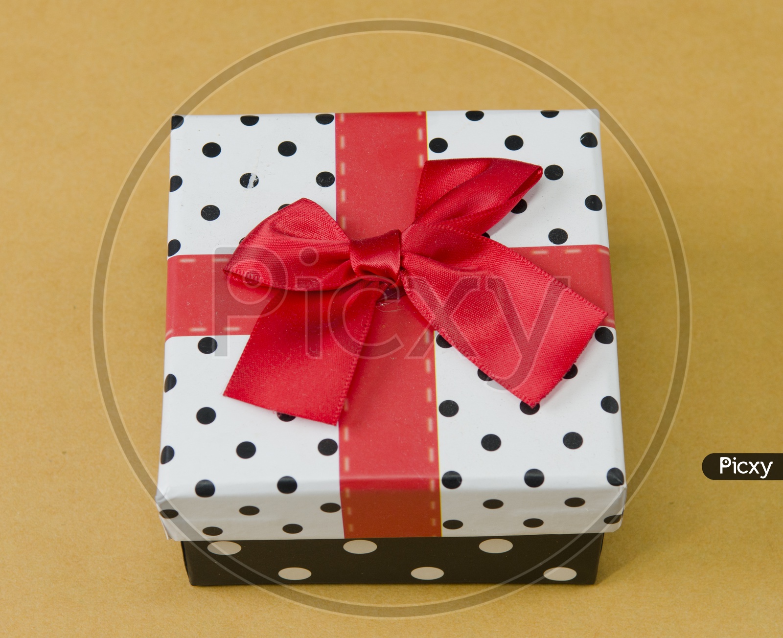 A Red ribbon tied to a gift box