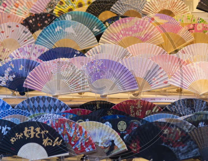 Colorful open hand fans in a store