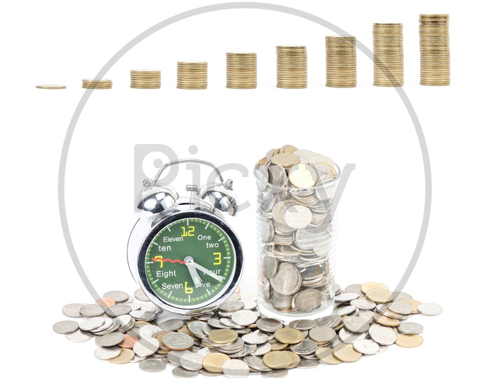 Alarm Clock With Currency Coins Mount On an Isolated White Background