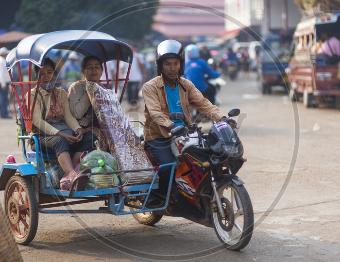 A Motorcycle Rickshaw Ride in  Luang Prabang Morning Market in Laos.
