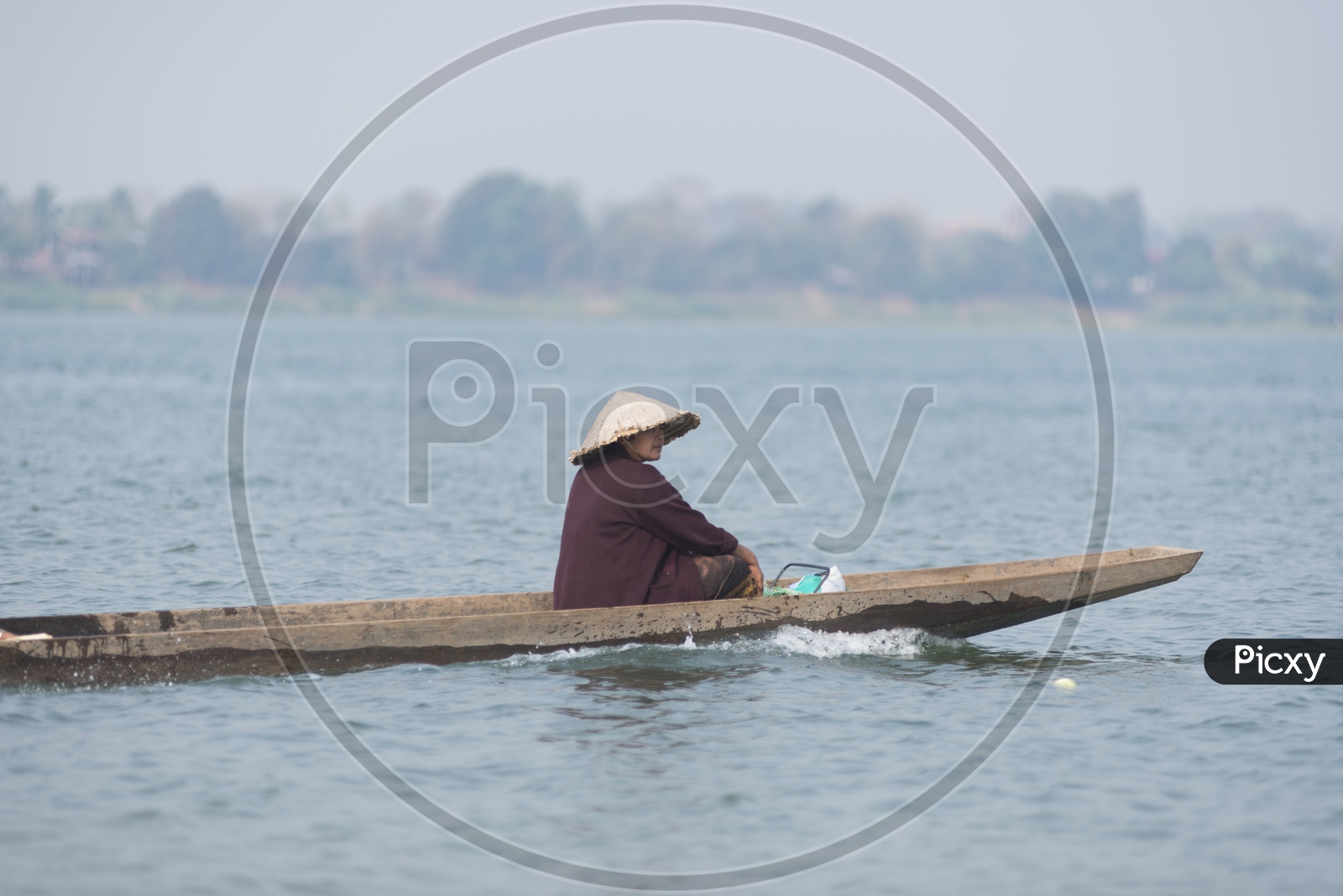 Unidentified Woman in a boat for crossing the border of Thailand and Laos at Ubon Ratchathani province in Thailand