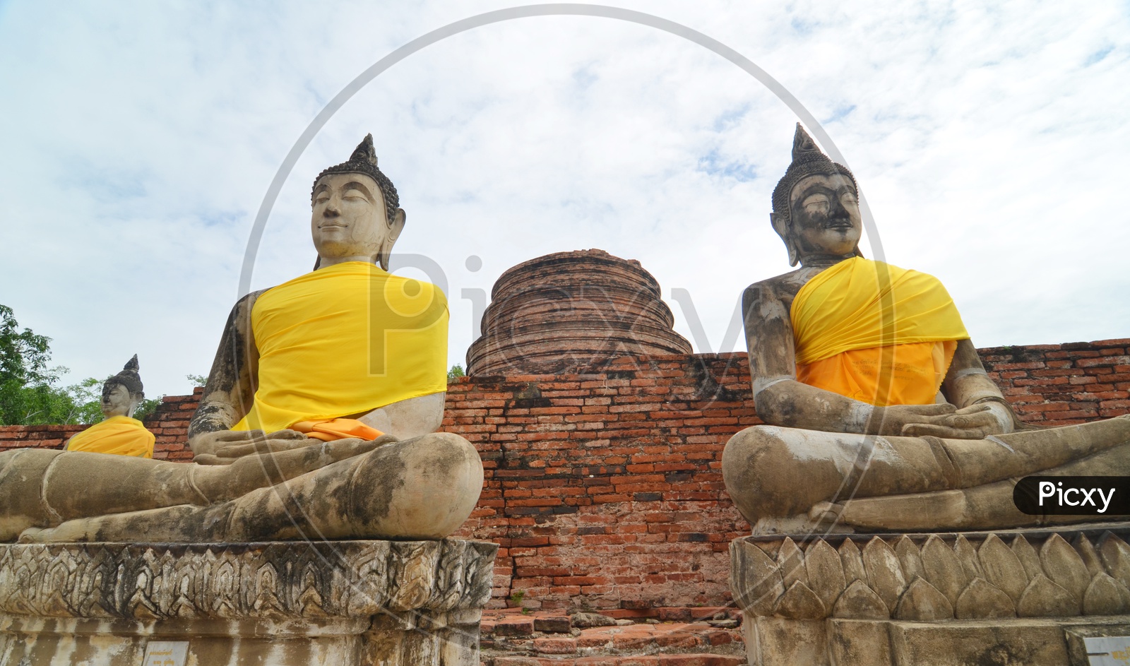 Ancient Buddha Statues O=and pagodas at  Wat Yai Chai Mongkol at Ayutthaya, Thailand