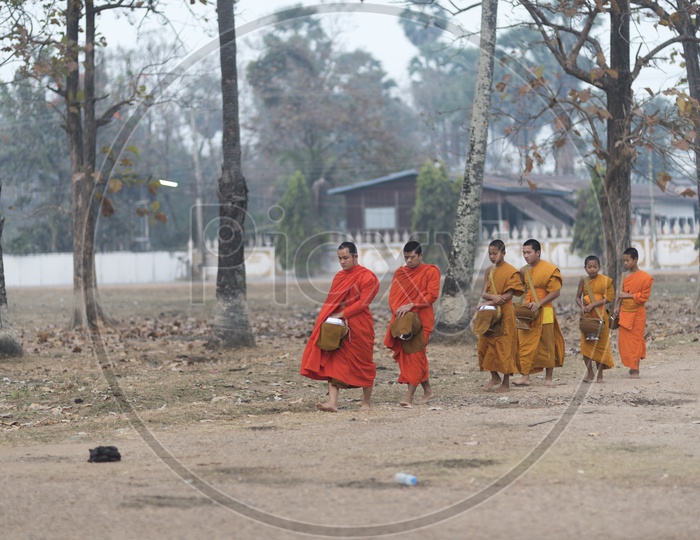 Buddhist monks Luang Prabang, Laos carrying the food