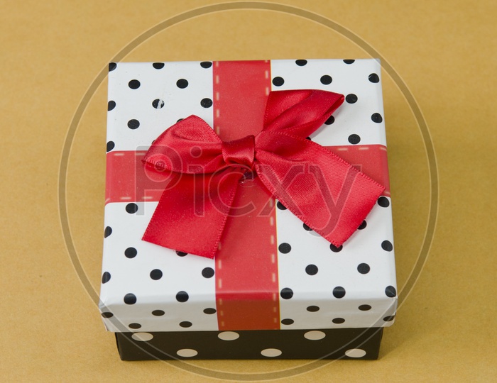 A Red ribbon tied to a gift box