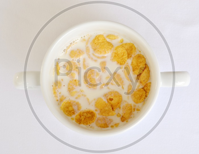 Cornflakes With Milk in a Bowl  Breakfast over Isolated White Background