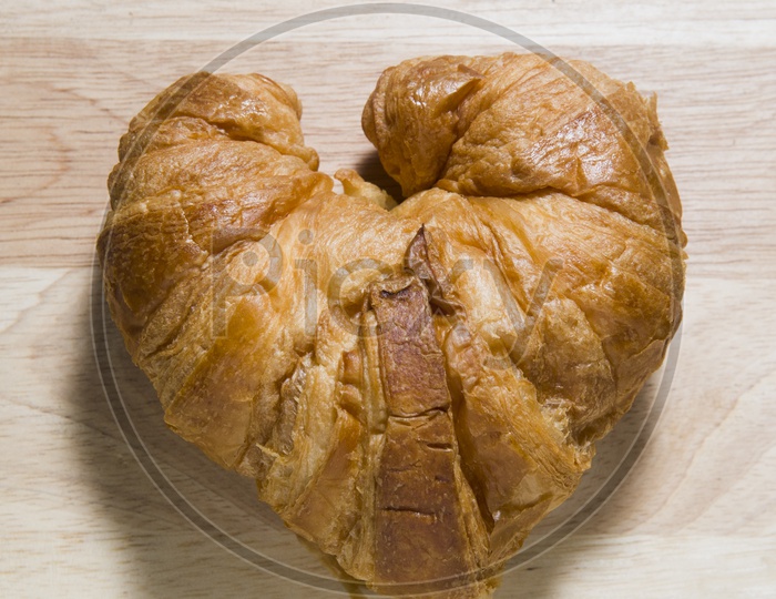 Fresh and tasty Croissant on wooden background