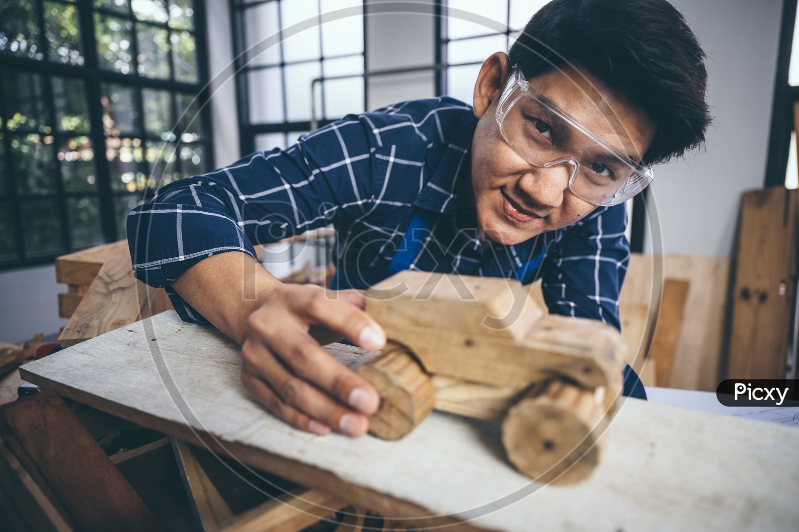 A Thai Carpenter exhibiting his wood craft