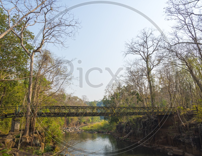 A Landscape of bridge over the water stream in Laos