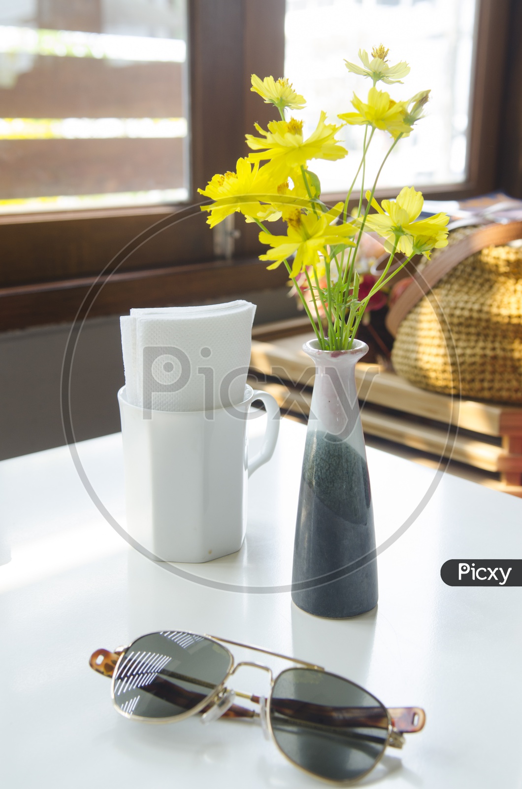 Cooling Glass on Table with Flower vase in Background