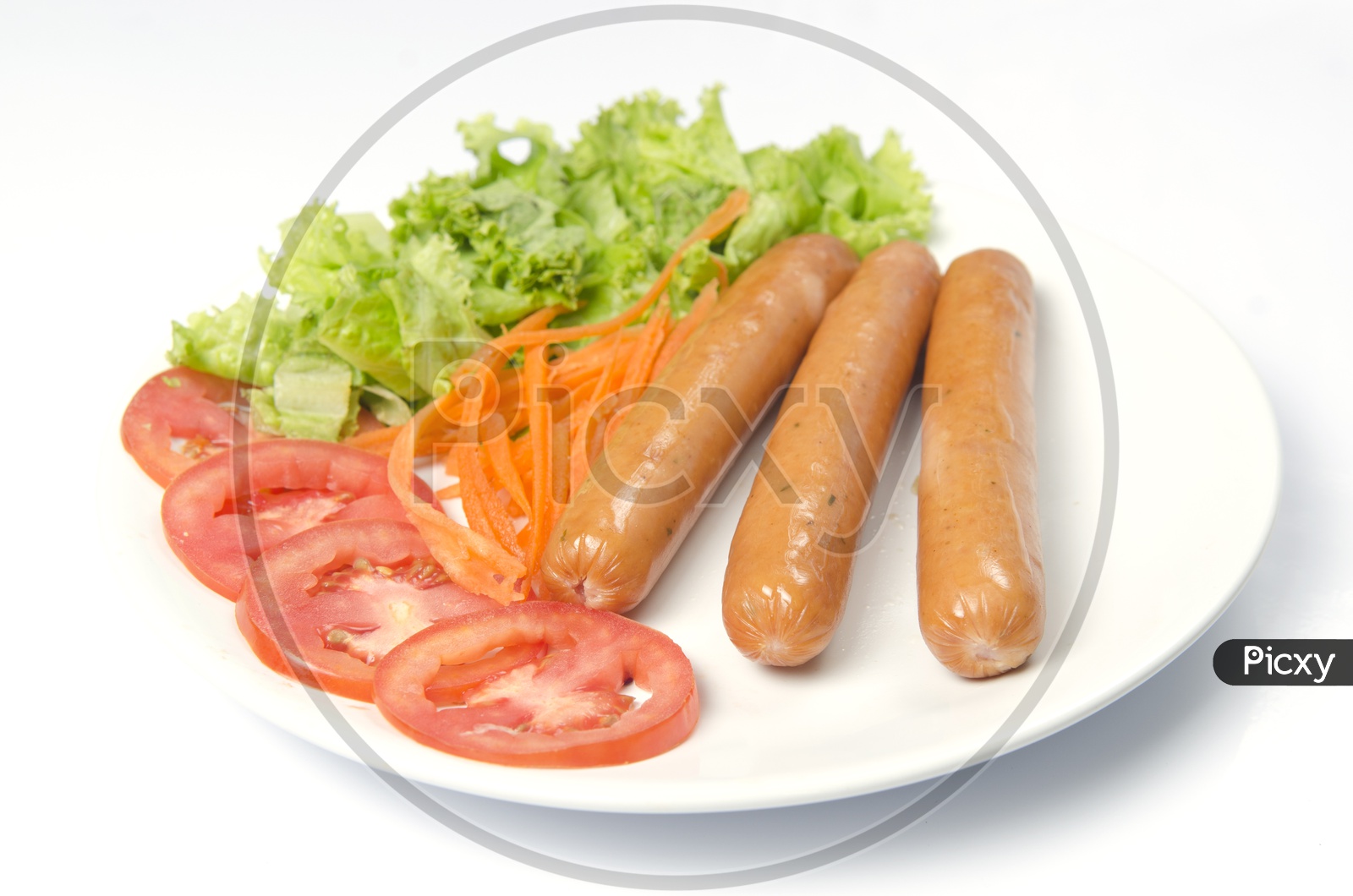 sausage and hot dogs garnished with vegetables isolated on white background