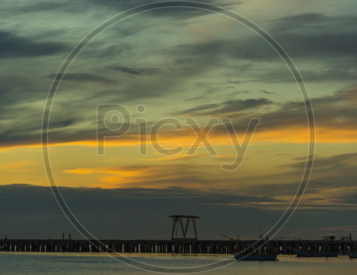 A Sea Pier with Beautiful Sunset in Sky Background