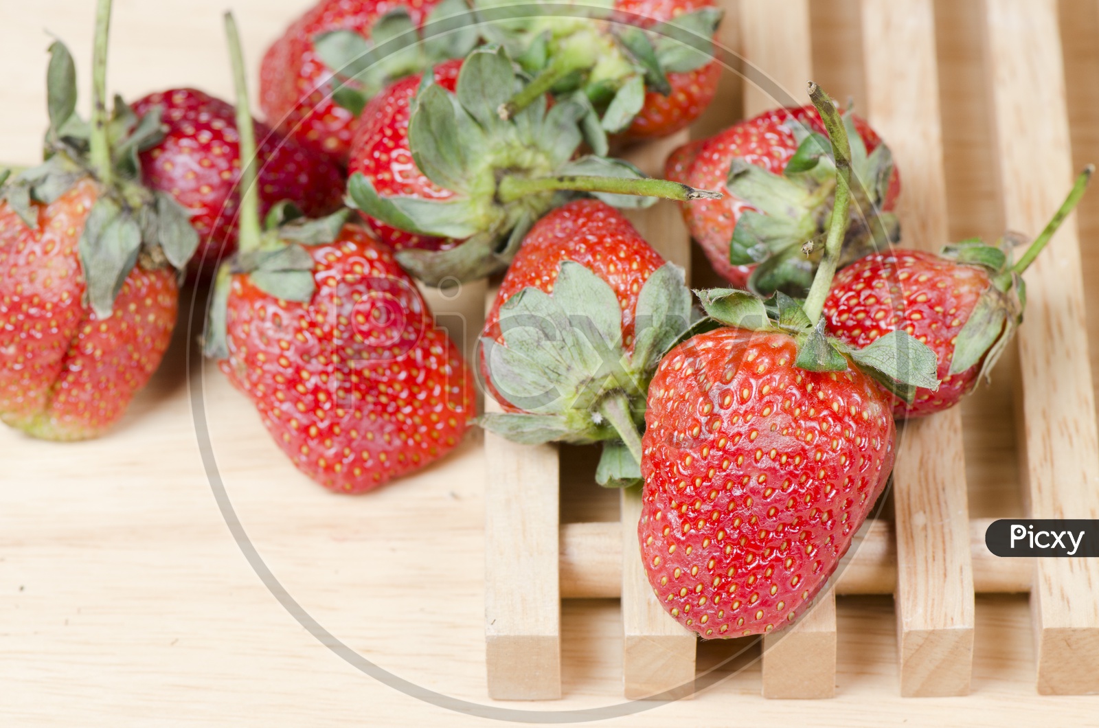 Delicious Strawberries isolated on wooden background