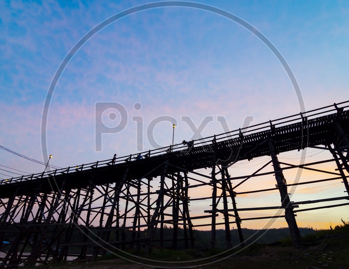 Silhouette of  Beautiful large antique wooden bridge  in the Thailand