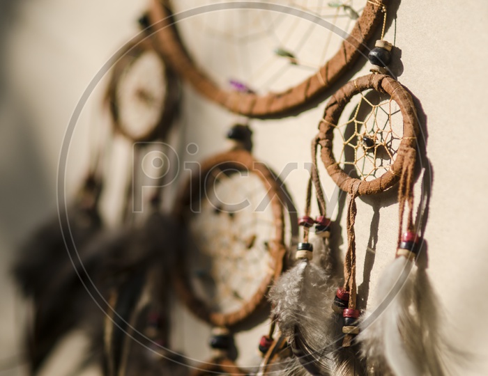 Dream-catchers Hanging Over a Wall Background