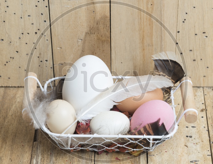 Easter eggs in a basket with wood background