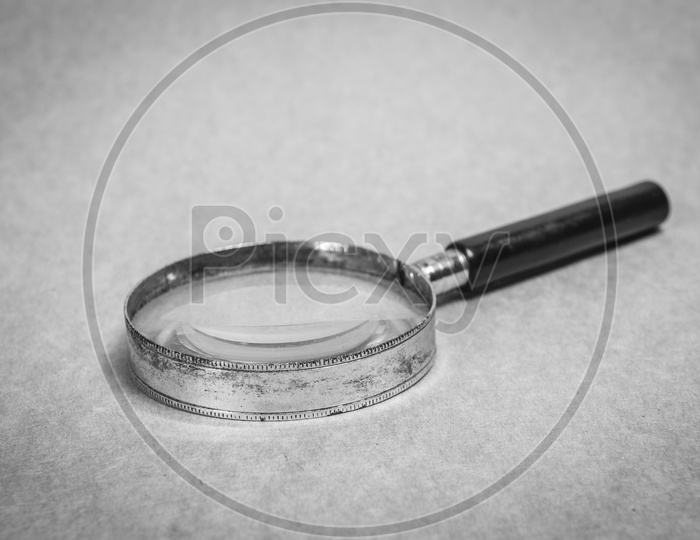 Authentic old metal magnifying glass in black and white
