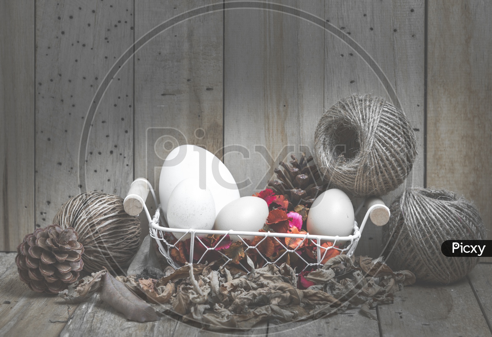easter eggs in a basket with wood background, vintage filtered Images