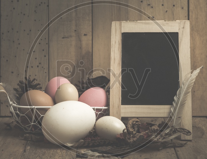 Easter Festival Creative Backgrounds with Easter Eggs over Wooden Background