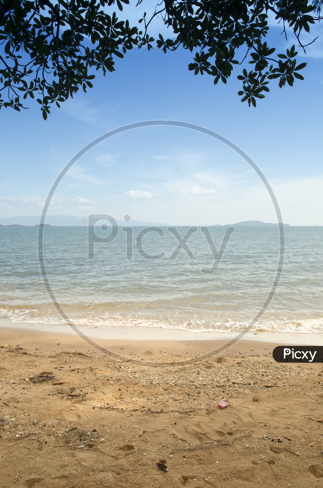 A Beautiful Beach with Mountains and Blue Sky in Background