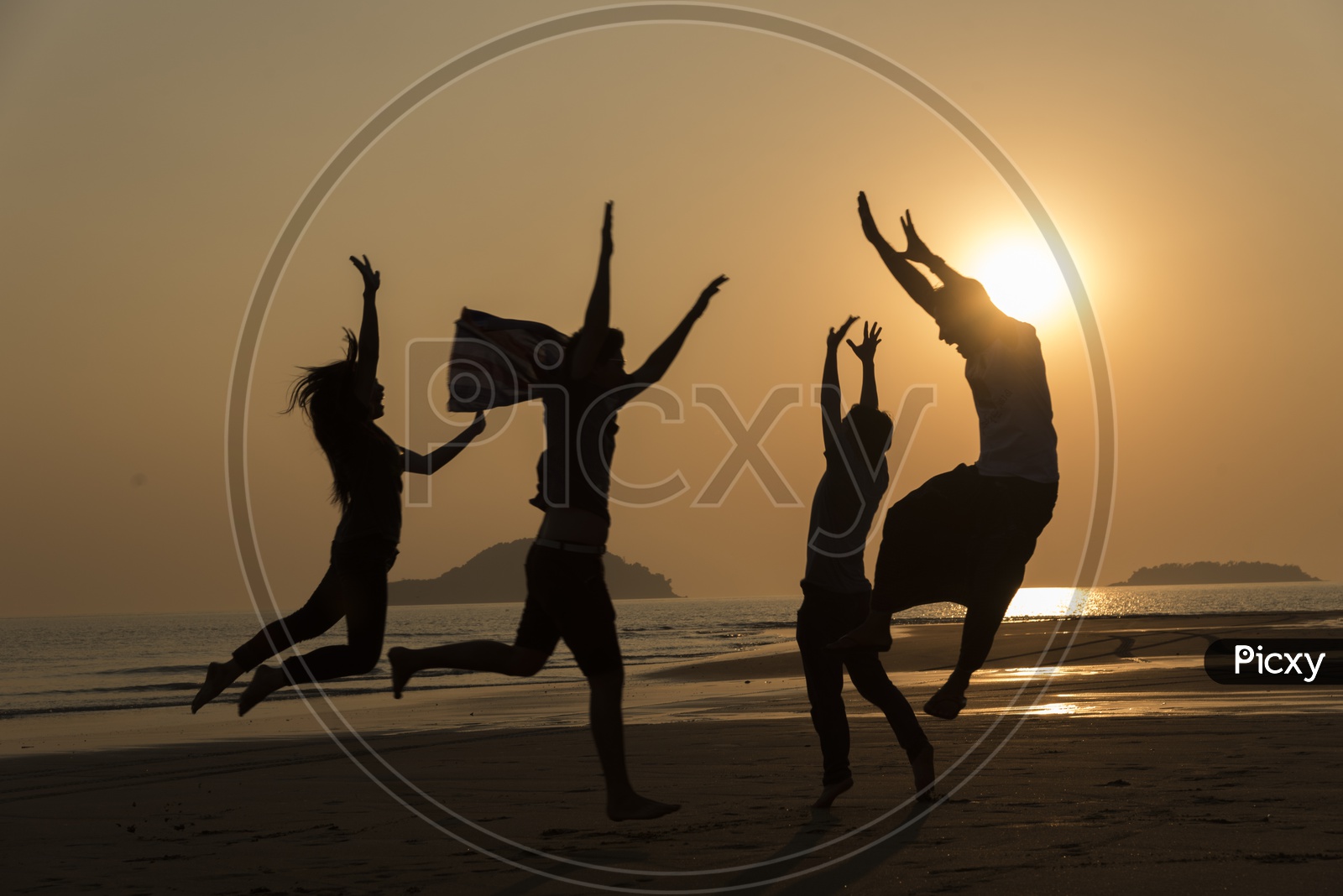 Silhouette pf  young people dancing and spraying at the beach in Thailand