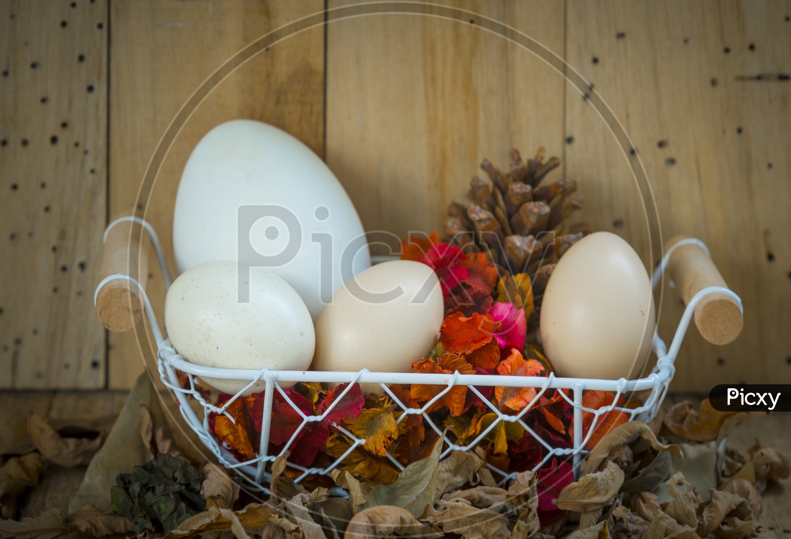 Easter Eggs in a basket with wooden background