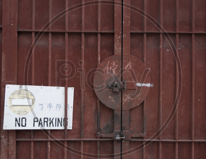 No Parking signage on the iron door