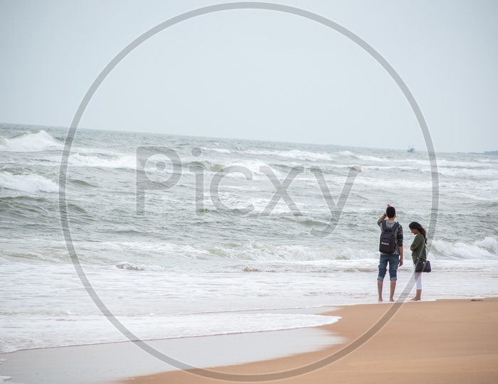 Couple at Candolim beach, Goa.