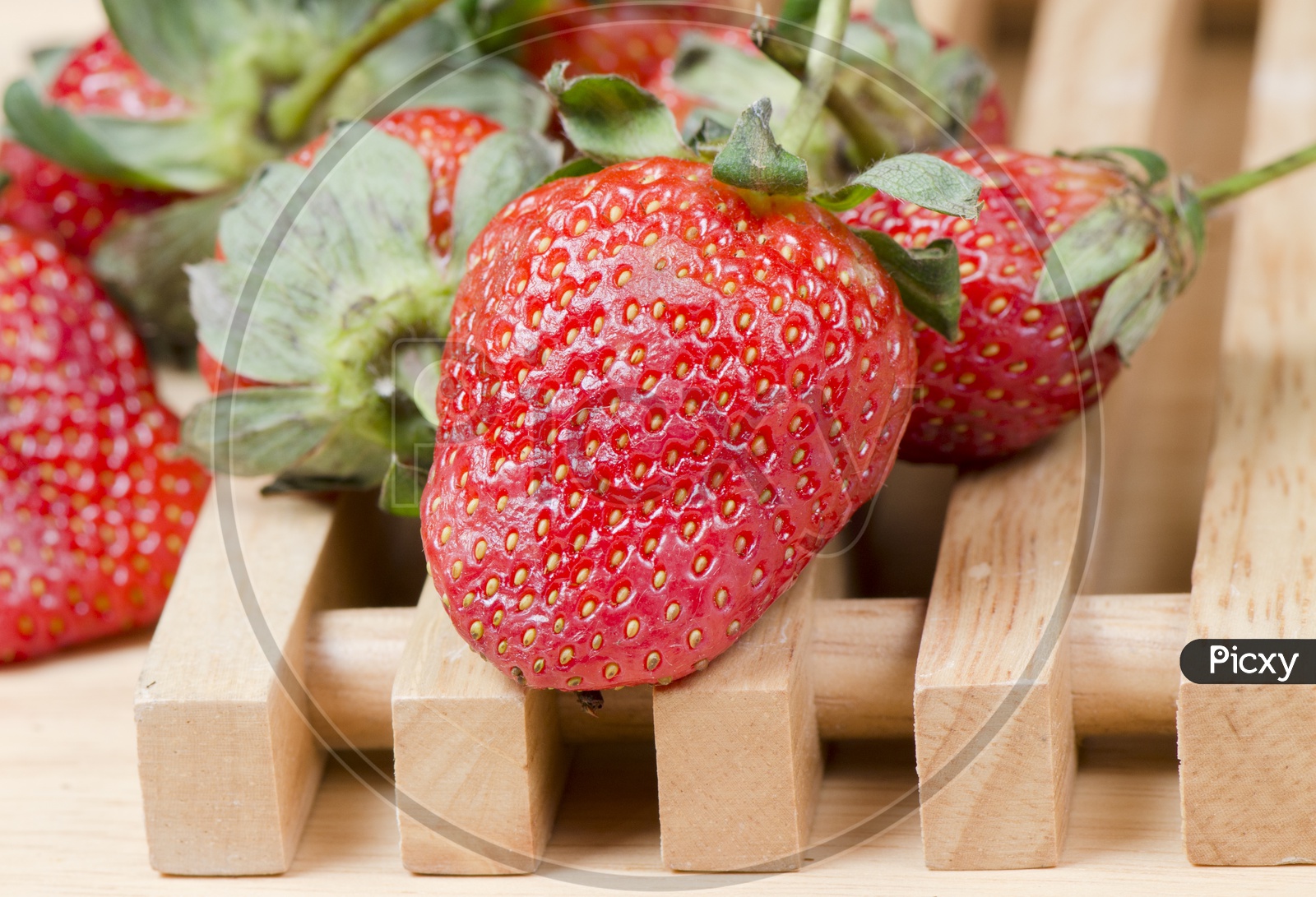 Delicious Strawberries isolated on wooden background