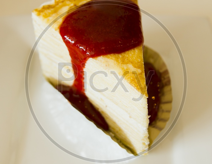 A cheesecake with sauce on the plate