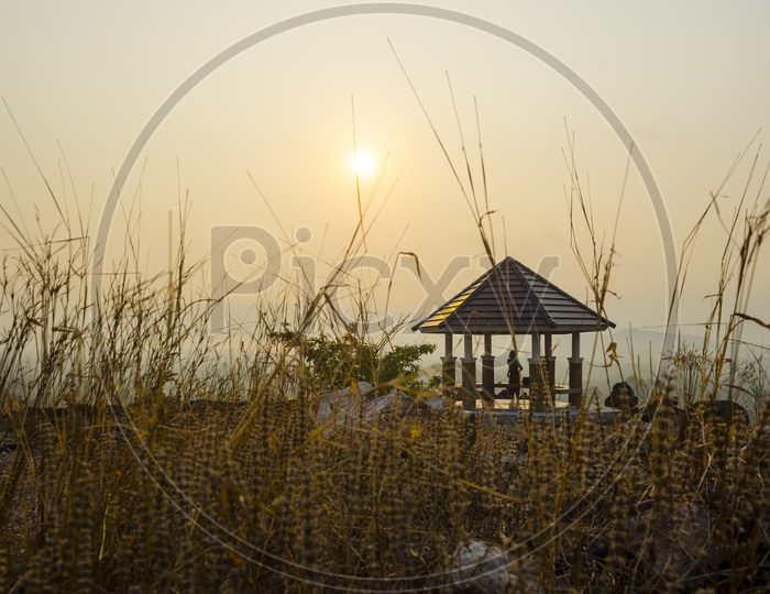 Sunset Over A Hill top With Pavilion