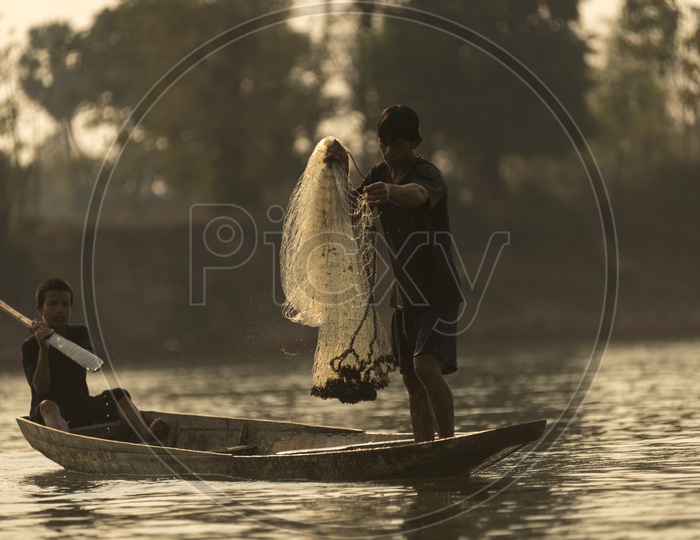 Fishermen along the banks of the Mekong river, Thailand and Laos.
