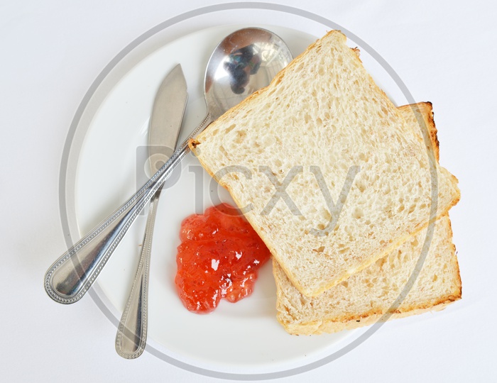 A good piece of toast with  Strawberry  Jam and Butter