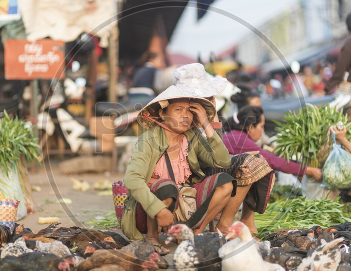 A Laos Woman selling leafy vegetables in Luang Prabang Morning Market in Laos.